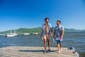 Gay couple walking together along a waterfront in Brazil